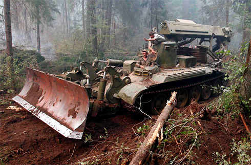 A military bulldozer makes a clearing in a forest in an attempt to halt the spread of fires in Russia's Kirzhach region on August 9, 2010.